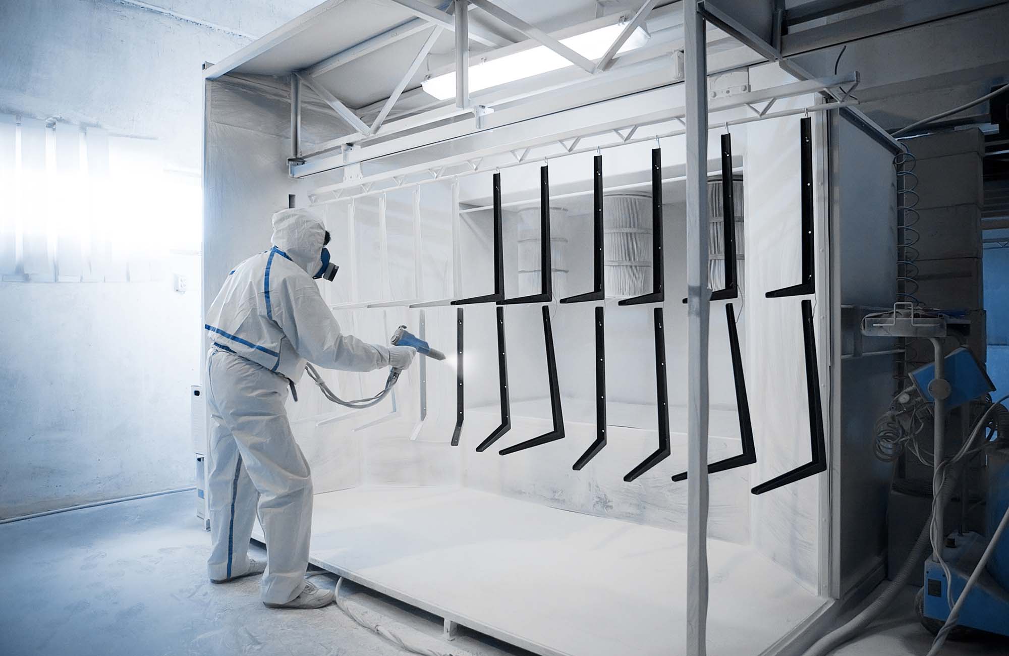 Worker at his workplace in powder coating room